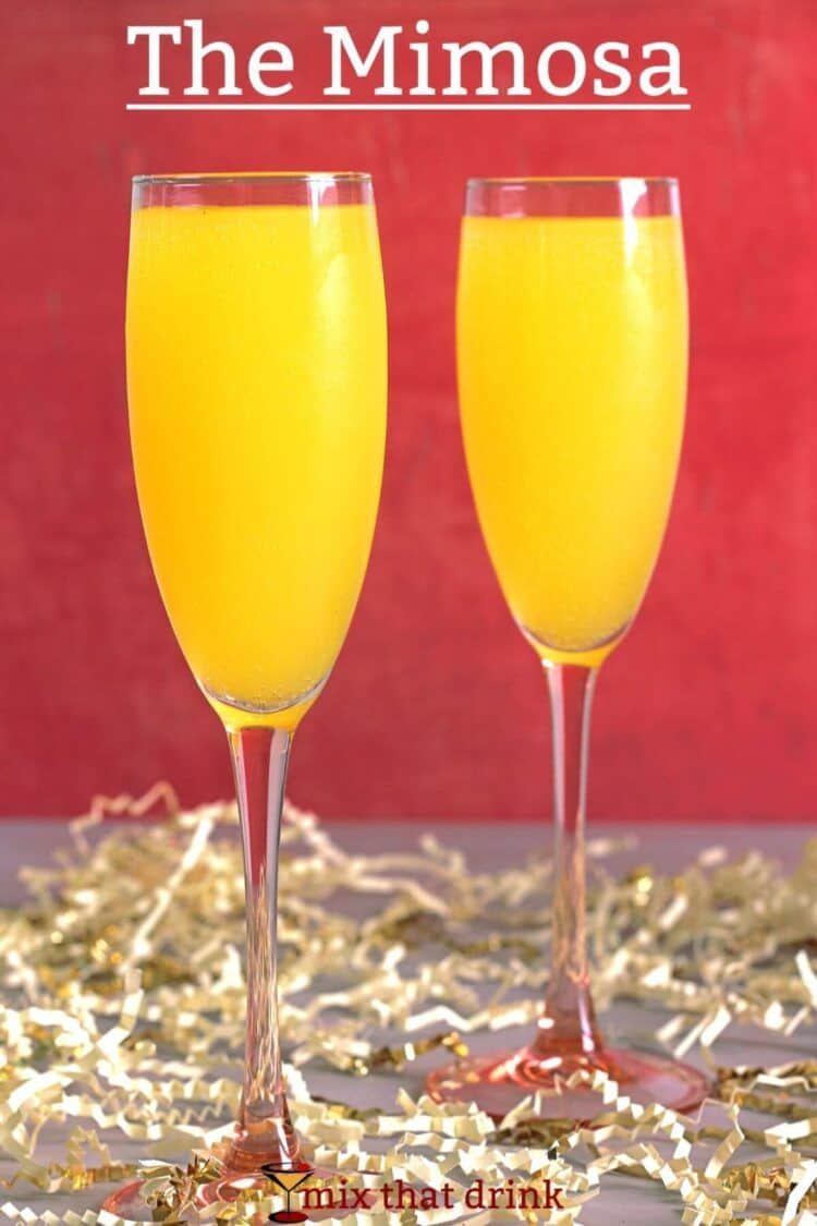 Mimosa cocktails on table against red backdrop