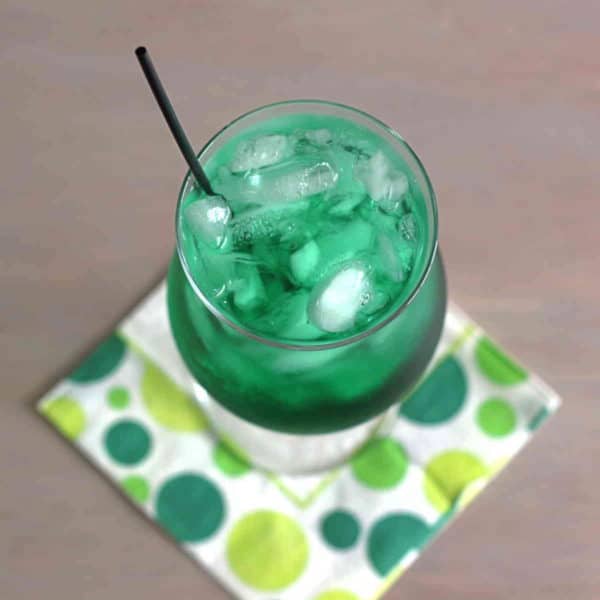 Overhead view of deep green Misty Mint cocktail on cocktail napkin