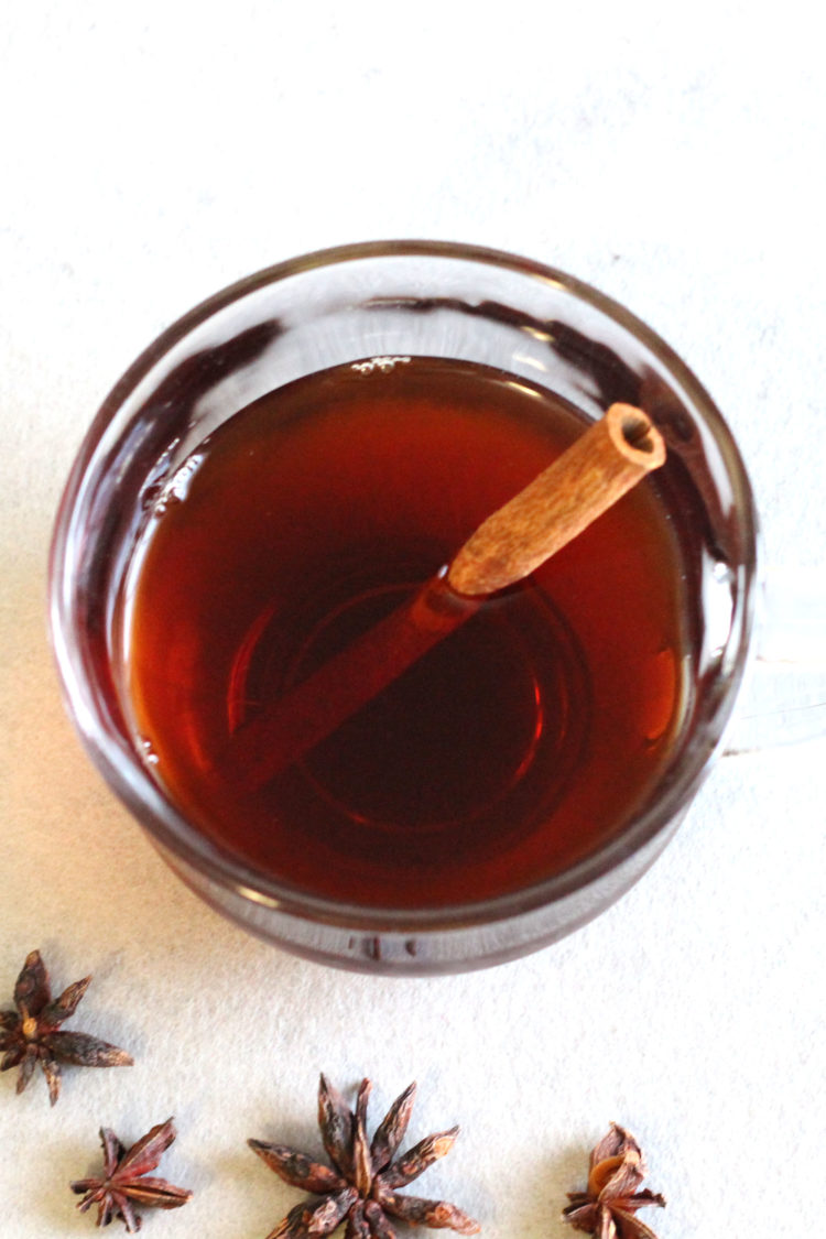 Overhead view of Mulled wine in glass mug with cinnamon stick