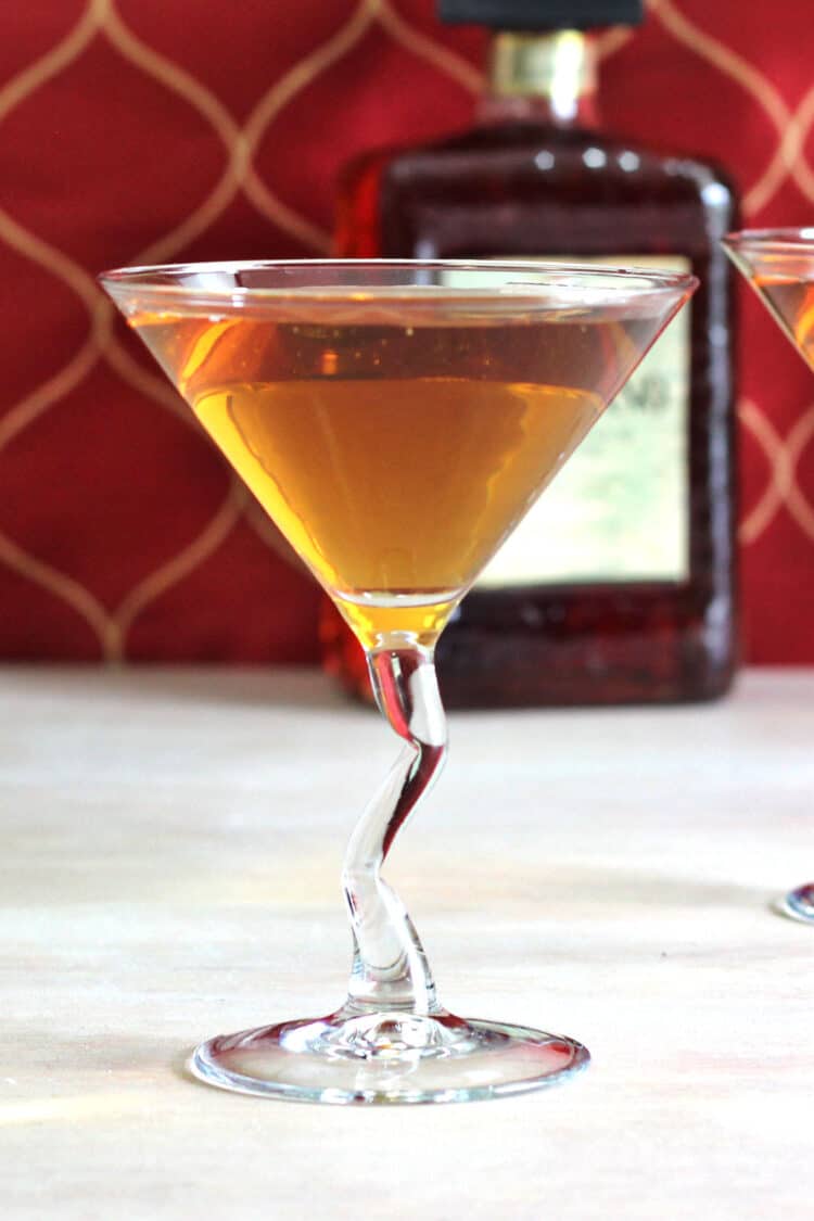 Closeup of Nilla Wafer Martini drink on a table in front of bottle of amaretto