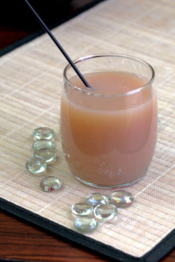 Nutcracker cocktail surrounded by glass pebbles