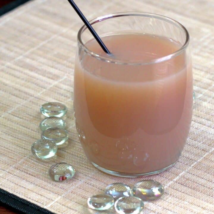 Nutcracker cocktail surrounded by glass pebbles