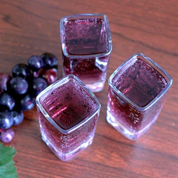 Pamoyo cocktail on table next to grapes