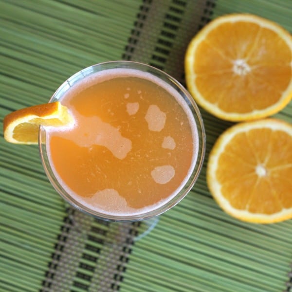 Overhead view of Pilgrim Cocktail with orange halves on table