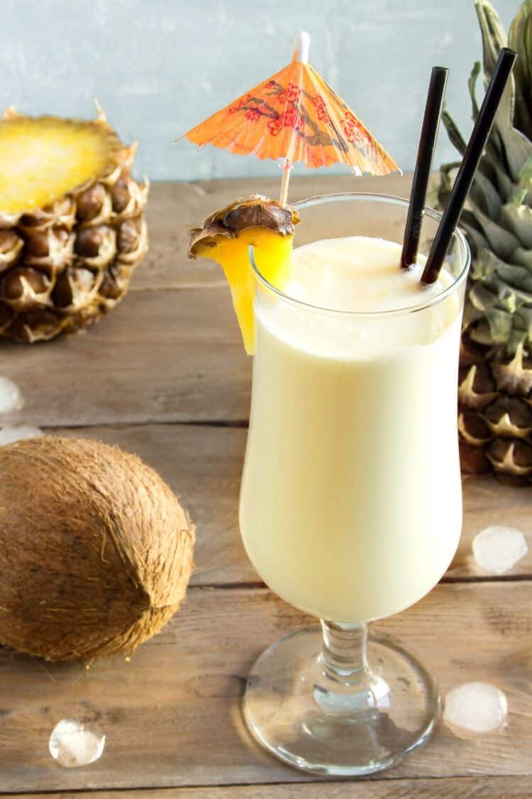 Angled view of Pina Colada drink on table with pineapple wedge