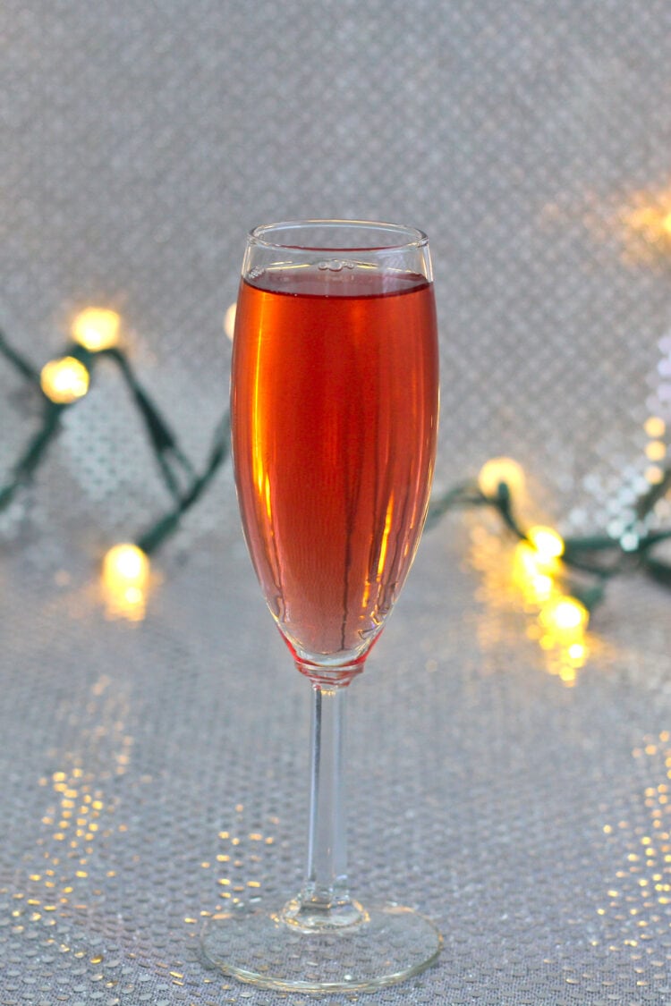 Poinsettia cocktail with Christmas lights in background