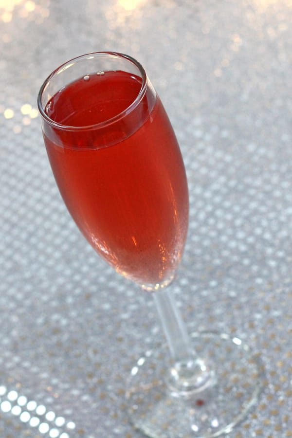 Tilted angle view of Poinsettia cocktail in champagne flute