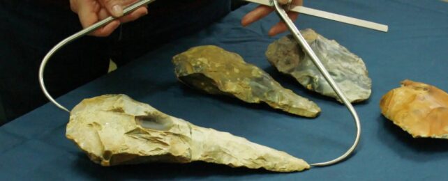 Prehistoric Axes Being Measured