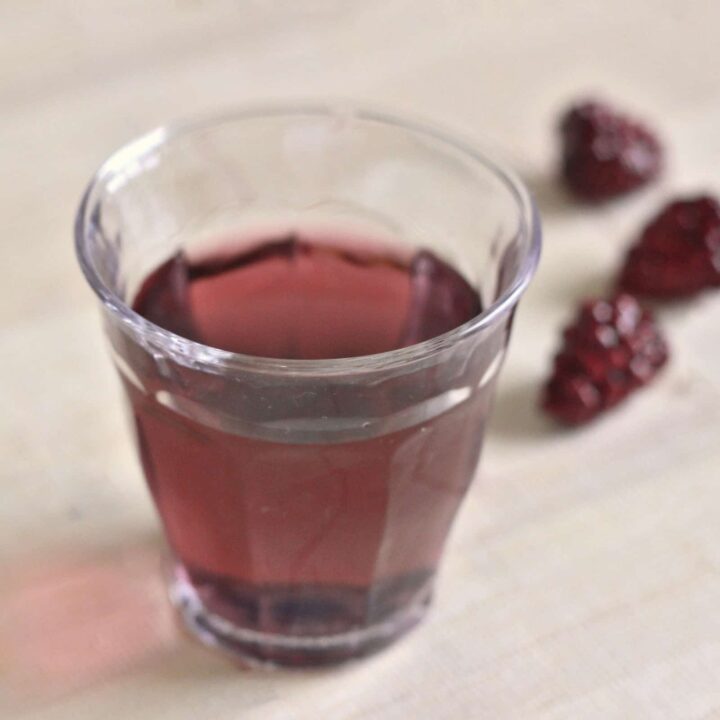 Purple Hooter Shooter on table with raspberries