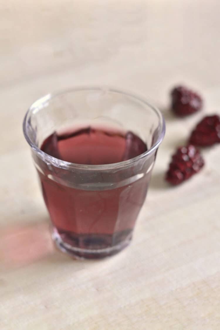 Purple Hooter Shooter on table with raspberries