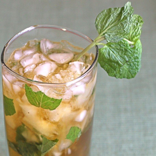 Closeup view of Queen's Park Swizzle drink with mint sprigs