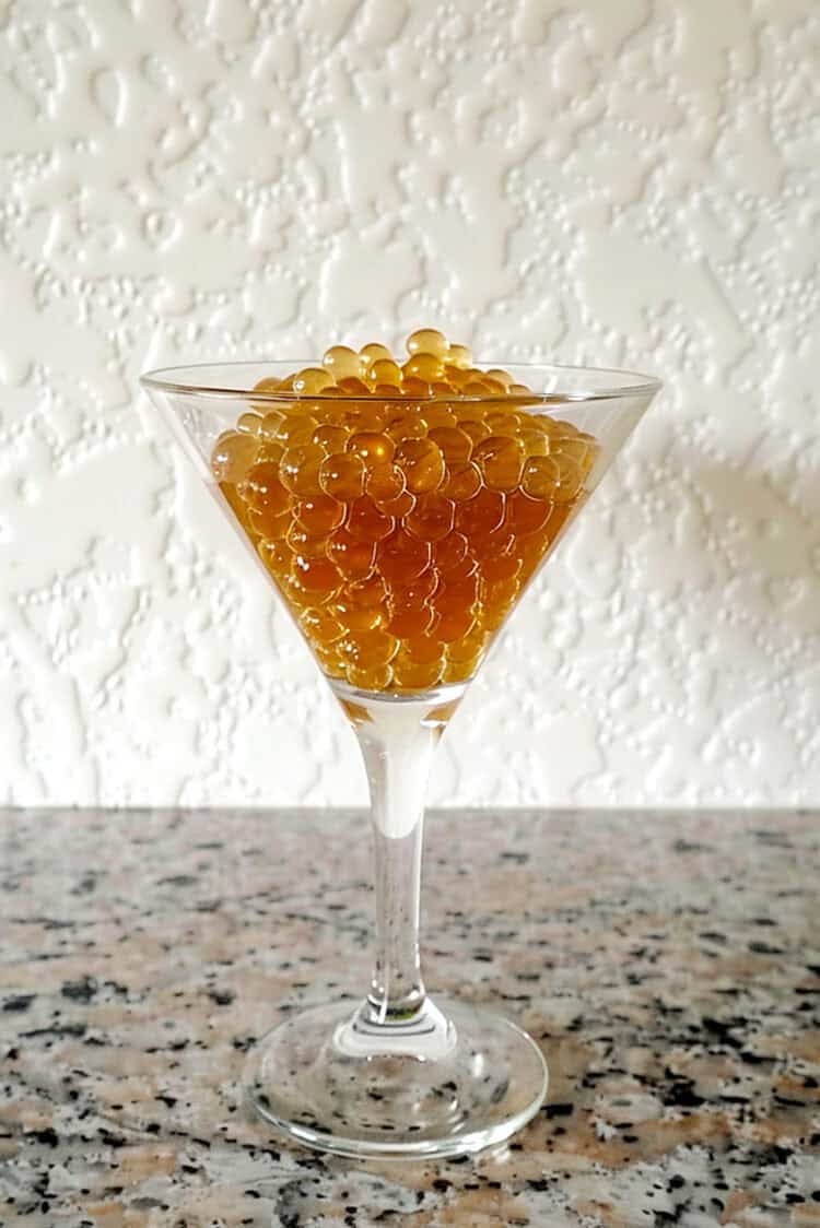 Rum caviar beads in martini glass