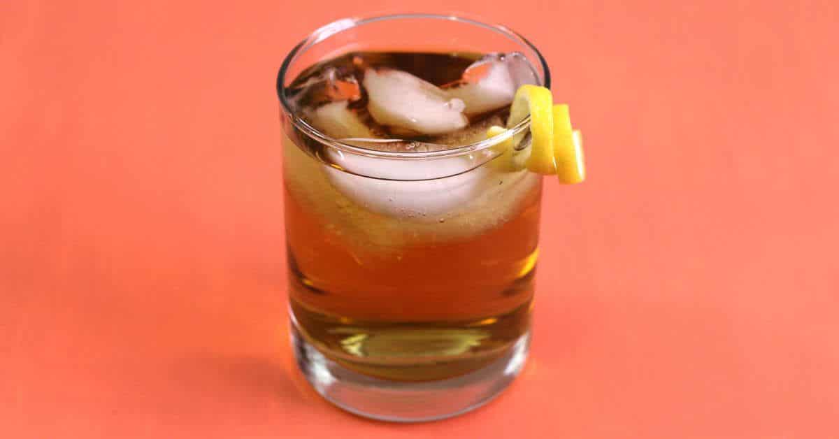 Rusty Nail cocktail with lemon twist