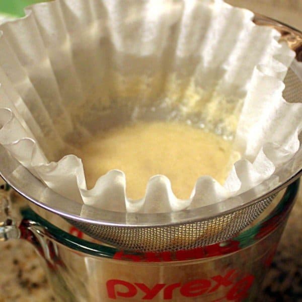 Pouring caramel vodka infusion through coffee filters