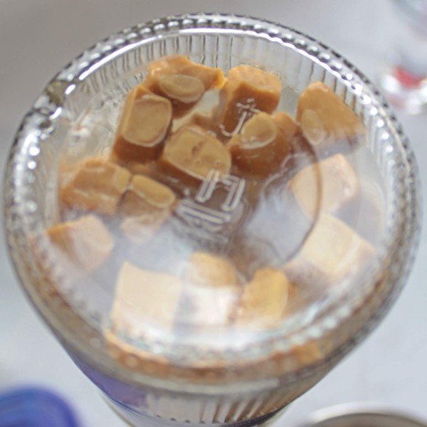 Caramel candies stuck to bottom of vodka bottle