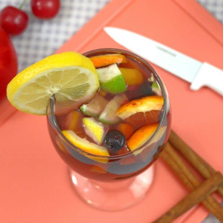 Sangria drink on cutting board with fruit