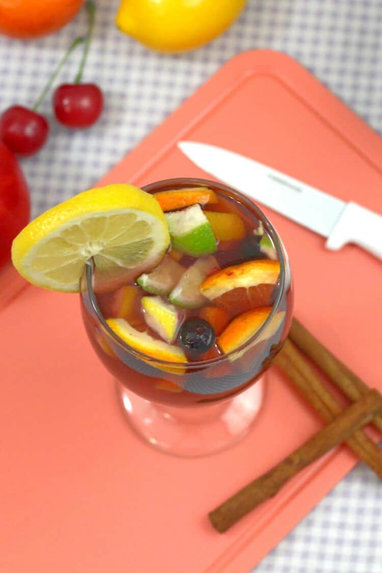 Sangria drink on cutting board with fruit