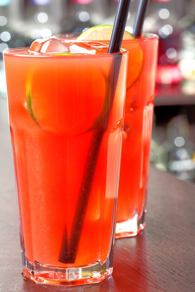 Sea Breeze drinks on bar in front of bottles