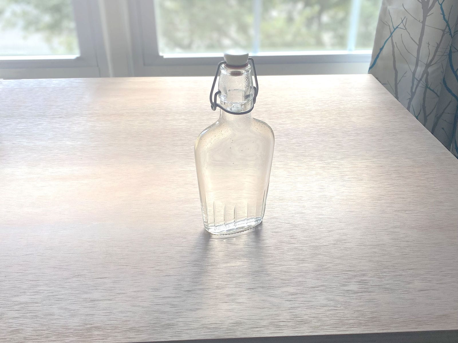 Bottle of simple syrup on table