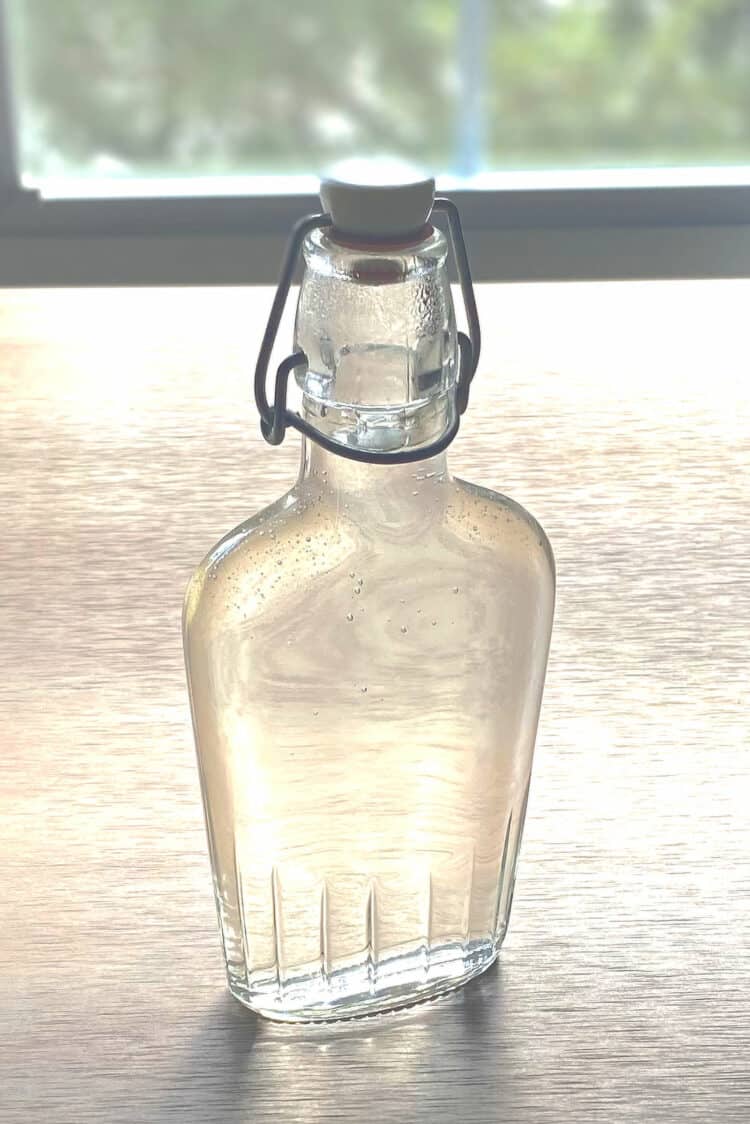 Bottle of simple syrup on table