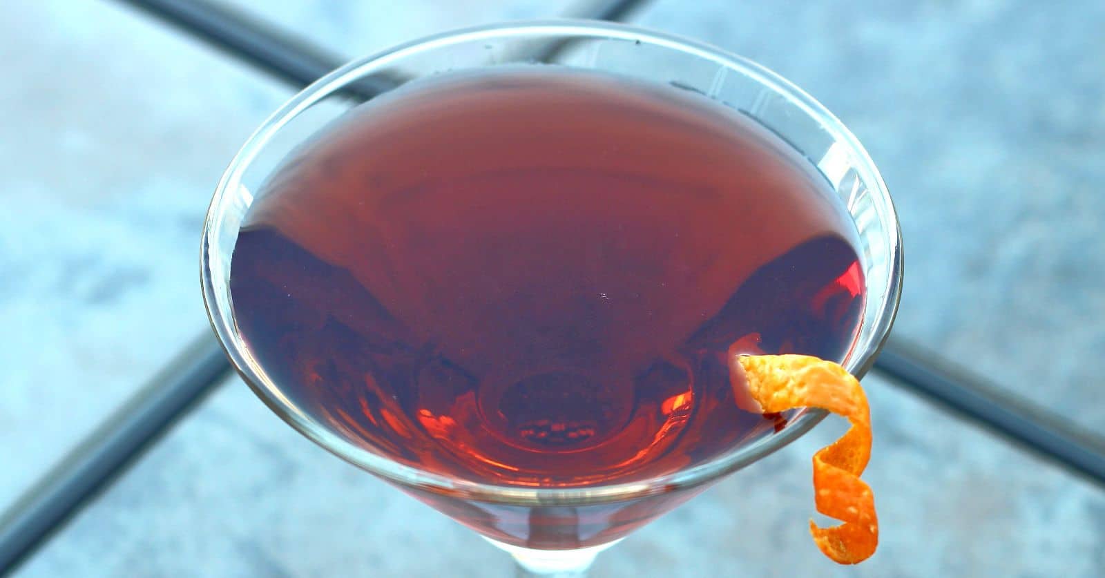 Cocktail featuring sloe gin on table