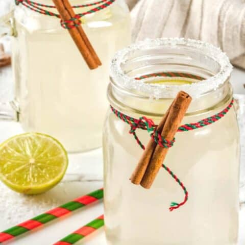 Snowball cocktail in mason jar with cinnamon sticks