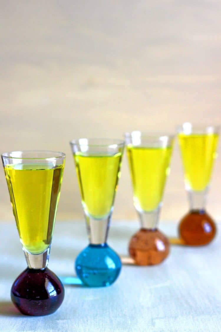 Bright yellow Sunny Mexico drinks lined up against a beige background