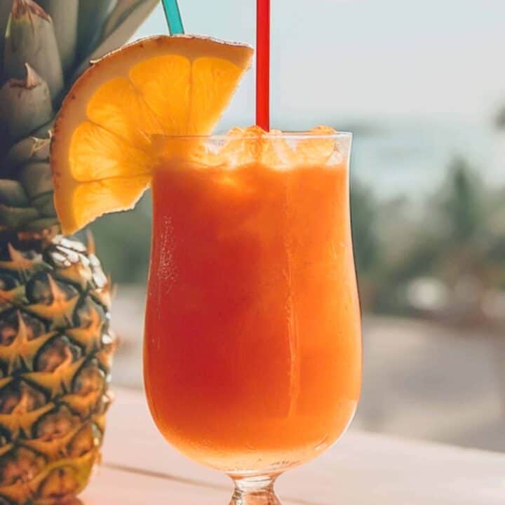 Sweet Tropics Cocktail on window sill in front of beach background