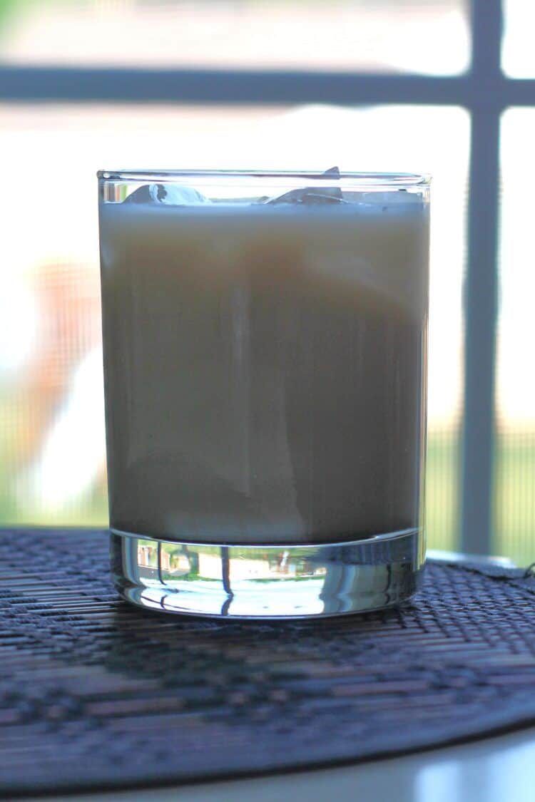 Toasted Almond drink sitting backlit in front of window