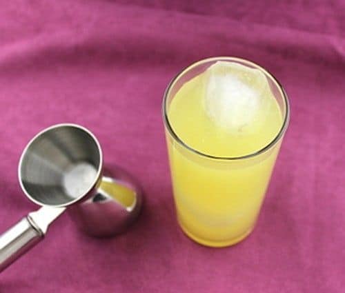 Top Banana drink beside a cocktail jigger