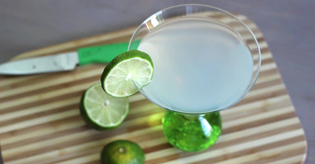 Tropical Rum drink on cutting board with limes