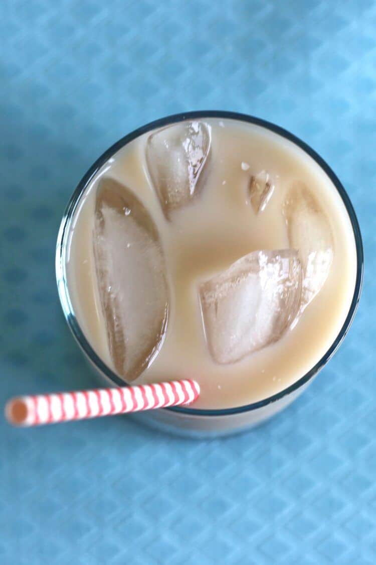 Overhead view of Velvet Hammer drink sitting on blue textured fabric