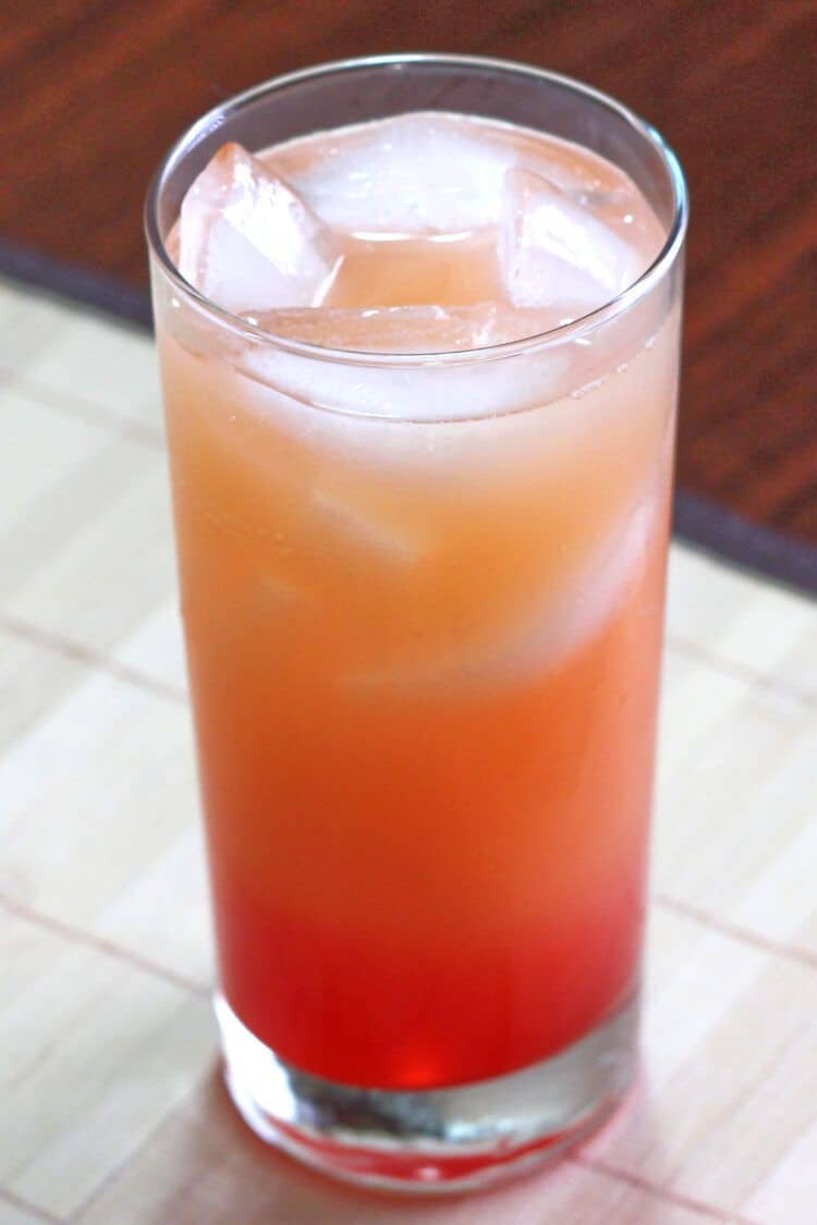 Orange and red Vodka Sunrise drink over ice