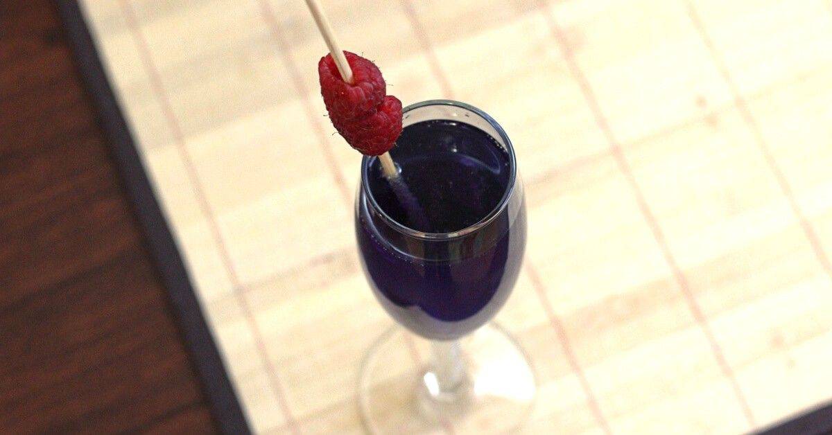 Volcano drink garnished with raspberries