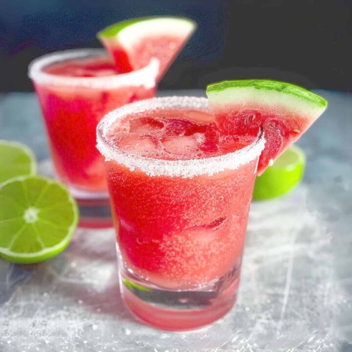 Watermelon Margaritas with sugar rim against black background