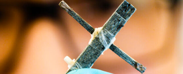 two lengths of balse made into a small cross, serving as a transistor