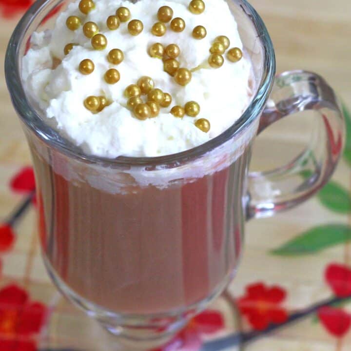 Xaviera cocktail with whipped cream and gold pearl sprinkles