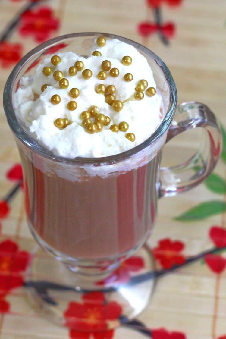 Xaviera cocktail with whipped cream and gold pearl sprinkles